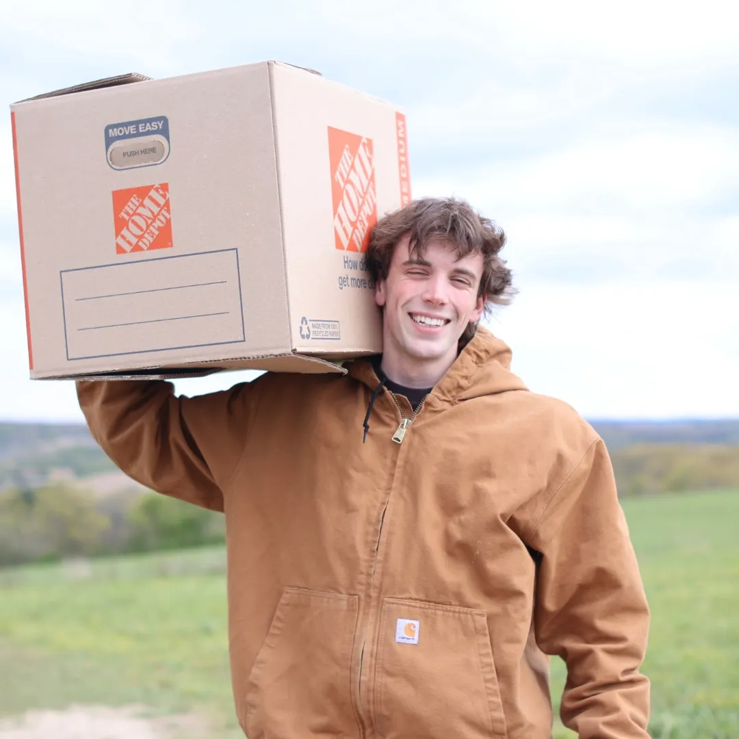 Monkey Movers crew member carrying a moving box during a local Milwaukee move