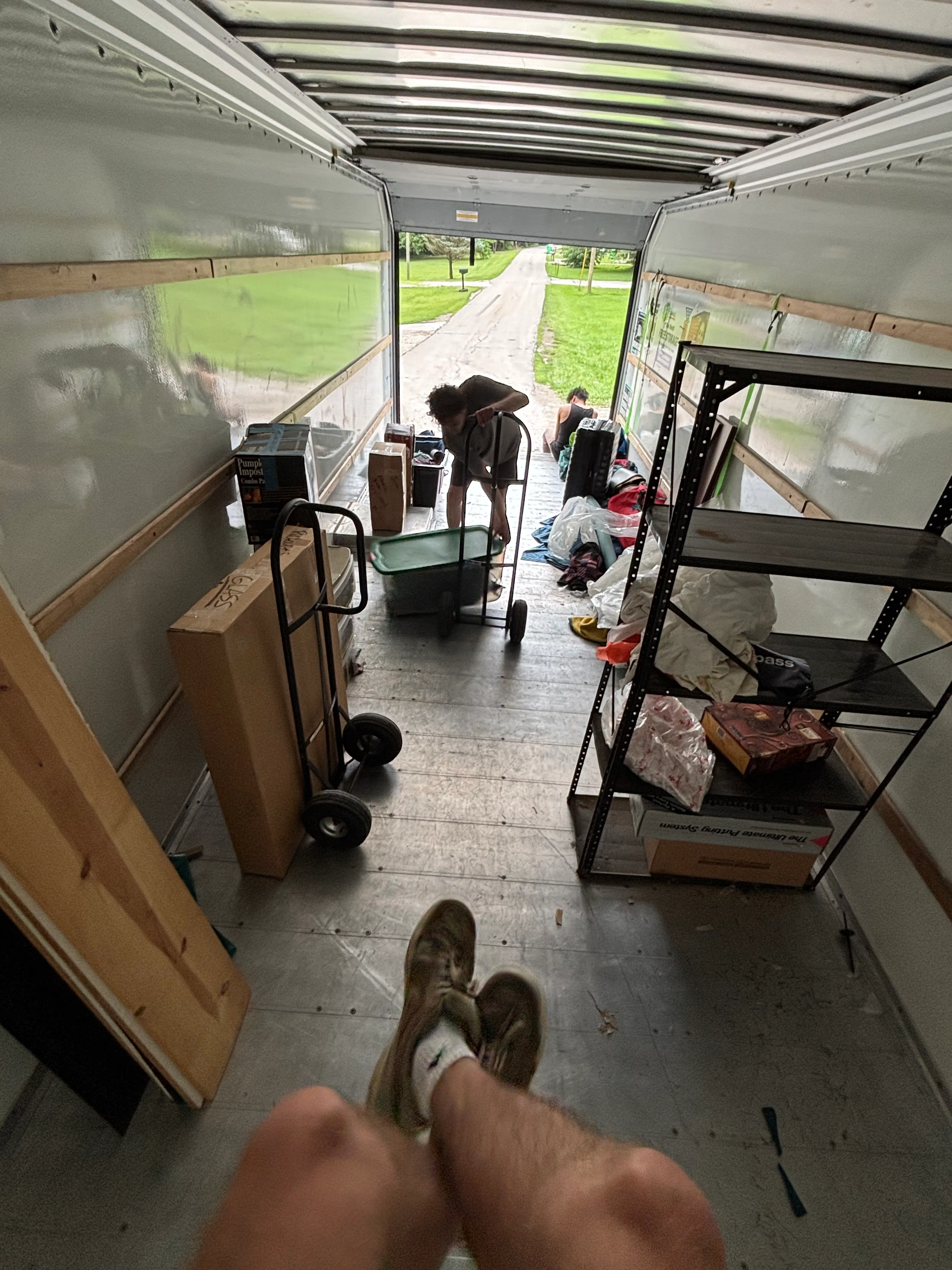 Monkey Movers crew loading boxes and shelving into the truck on a Milwaukee driveway