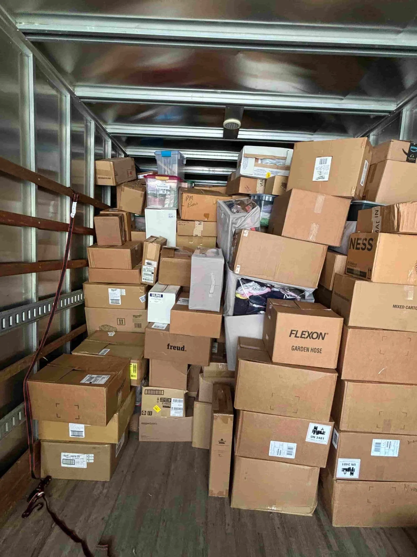 Moving boxes packed, labeled, and stacked neatly inside a Monkey Movers truck
